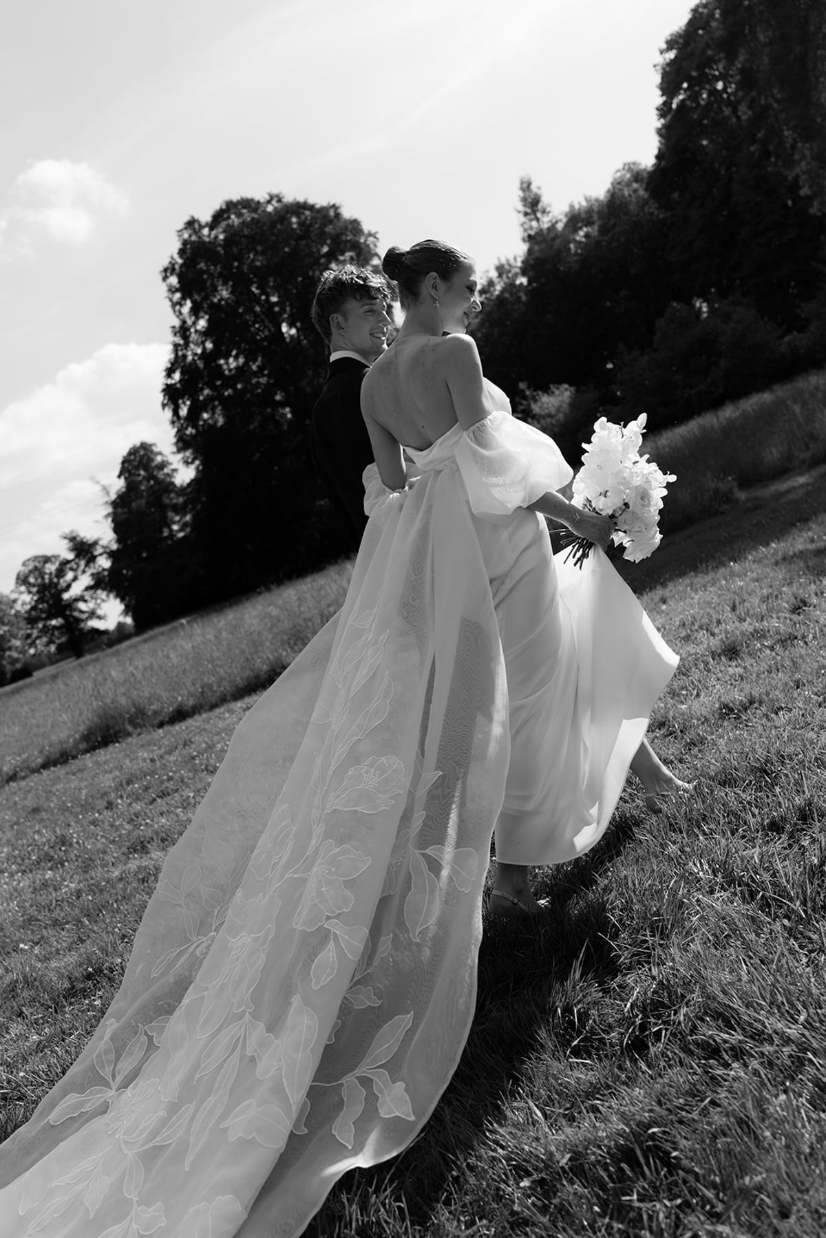Bride from behind holding her bouquet, black and white