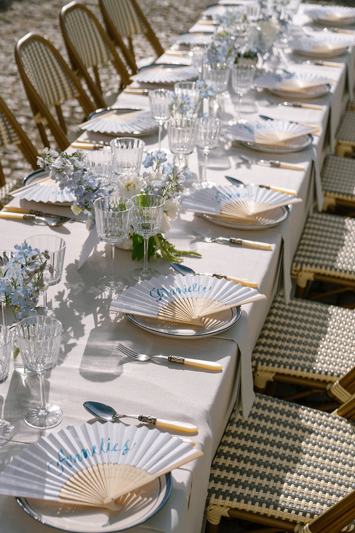 Table setting detail with a folded fan and place card