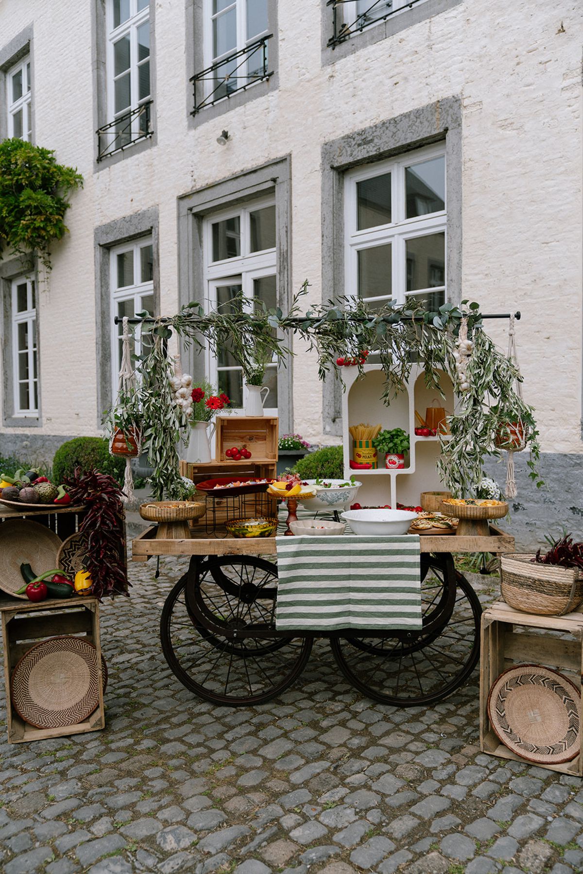 Styled food cart with fruit, bread and greenery