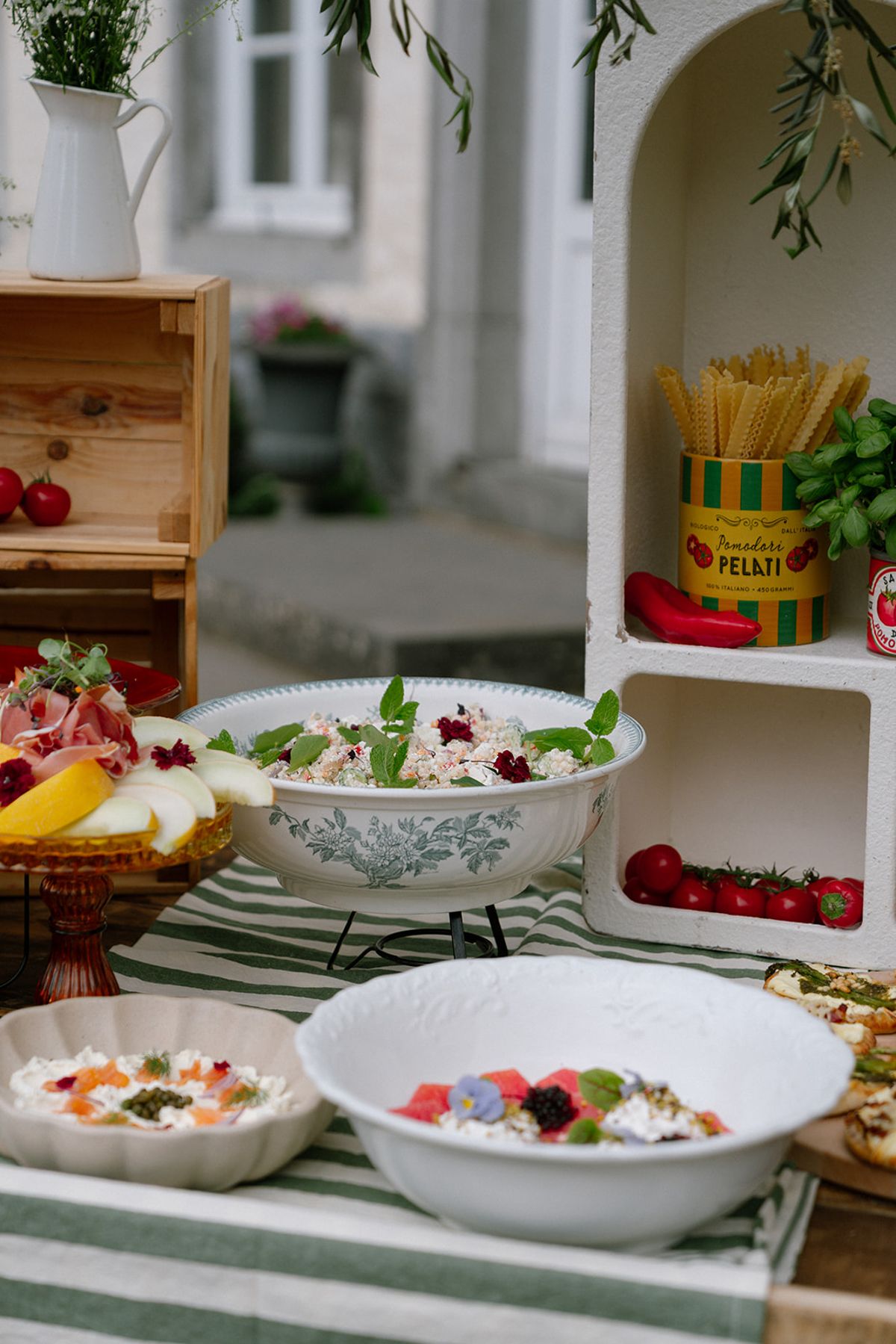 Fresh ingredients including tomatoes and melon styled on a lunch table