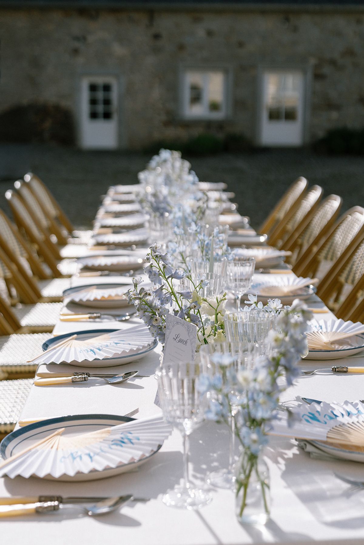 Blue and white table setting with a delphinium centrepiece and place cards