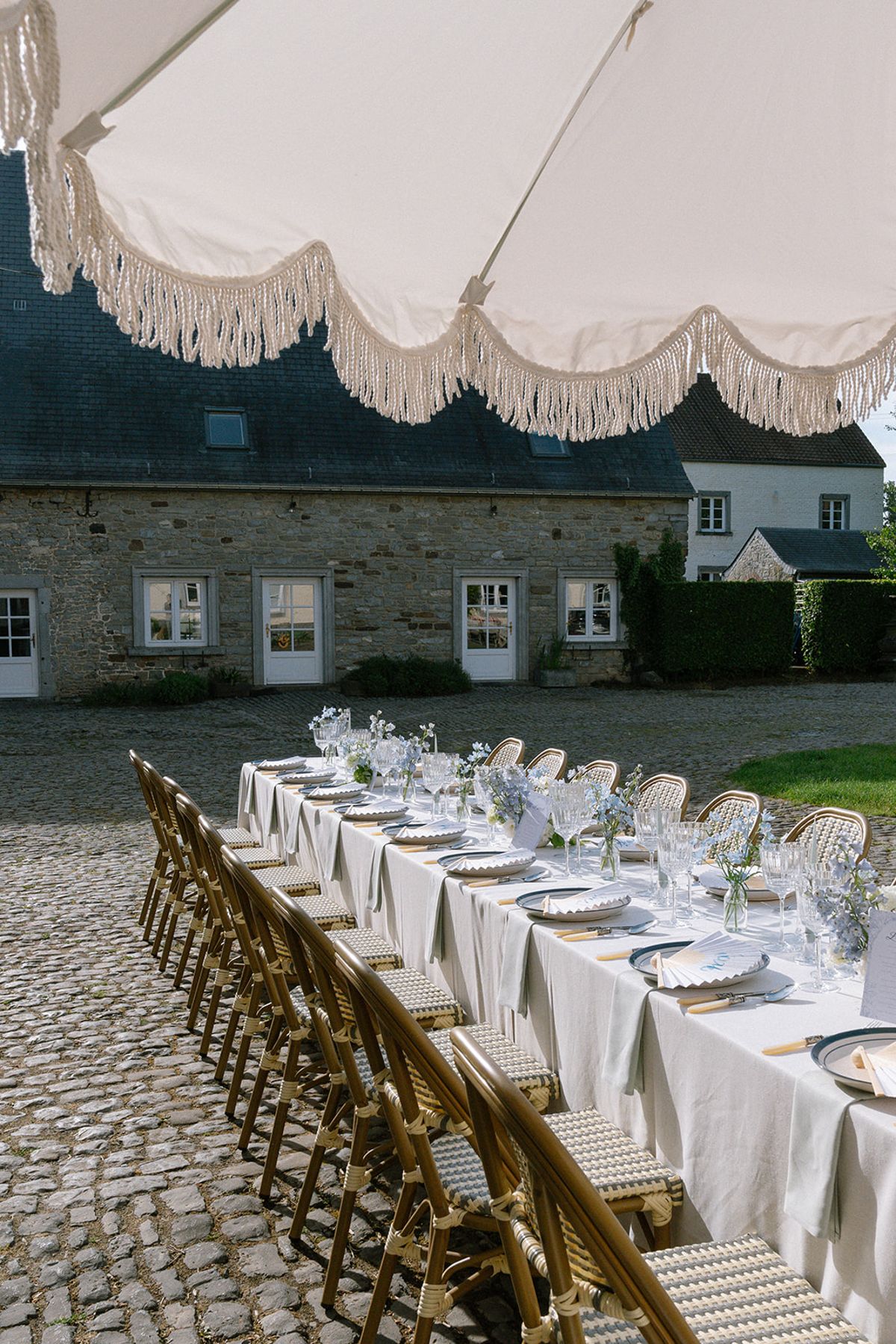 Reception table set for lunch in front of the chateau