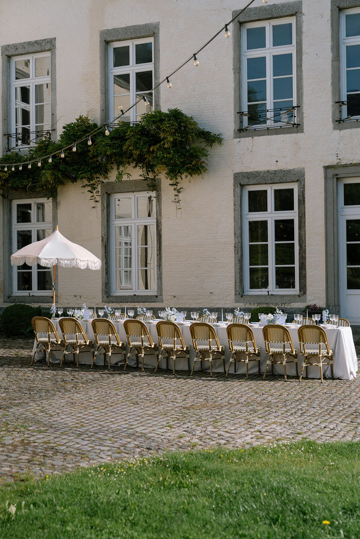Long reception table set in front of the chateau