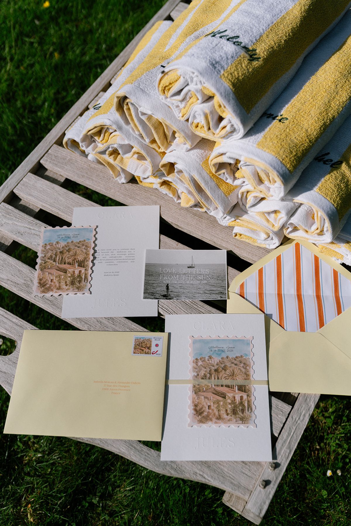 Striped towels and a menu card flat-laid on a poolside lounger