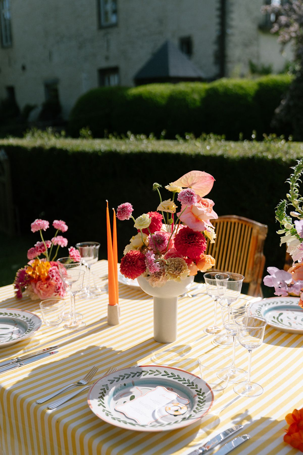 Pink and orange floral centrepiece on the reception table