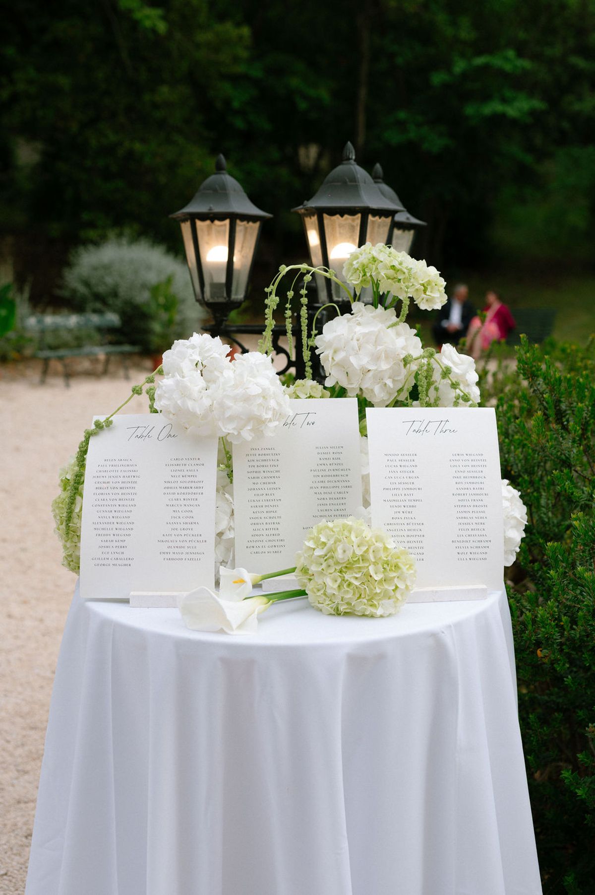 Table plan cards displayed beside a white hydrangea arrangement