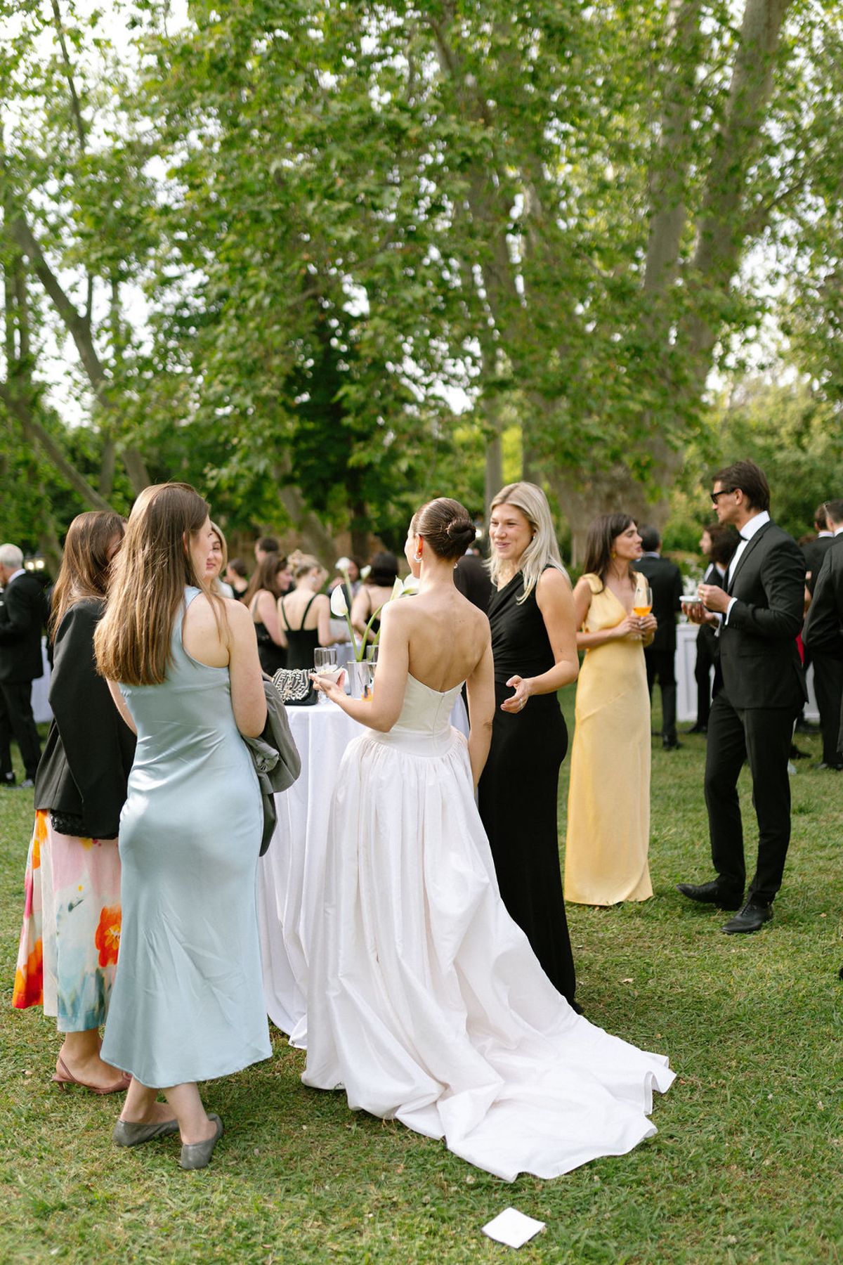Guests gather together outdoors during the cocktail hour