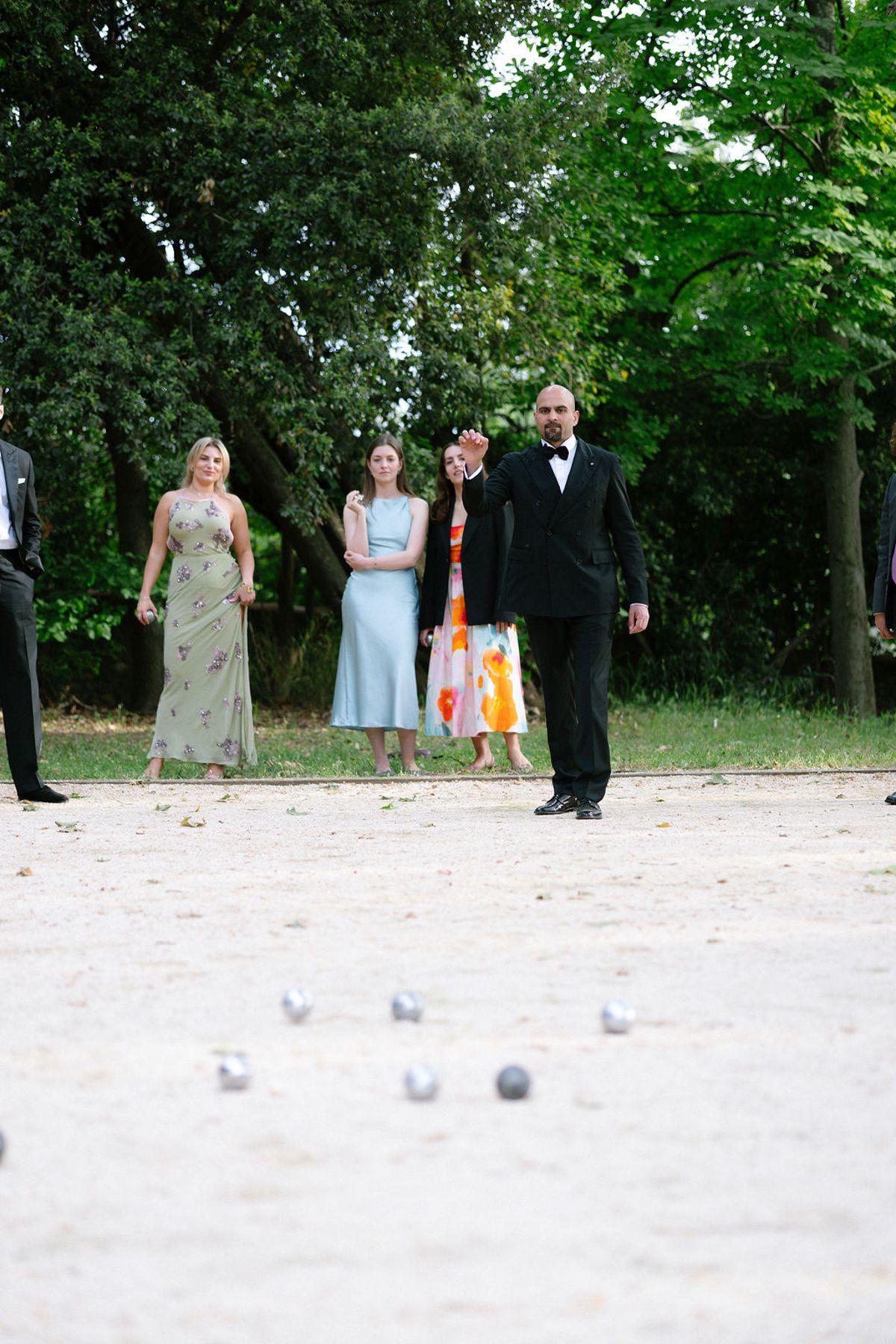 Guests in colourful dresses gather together during the cocktail hour