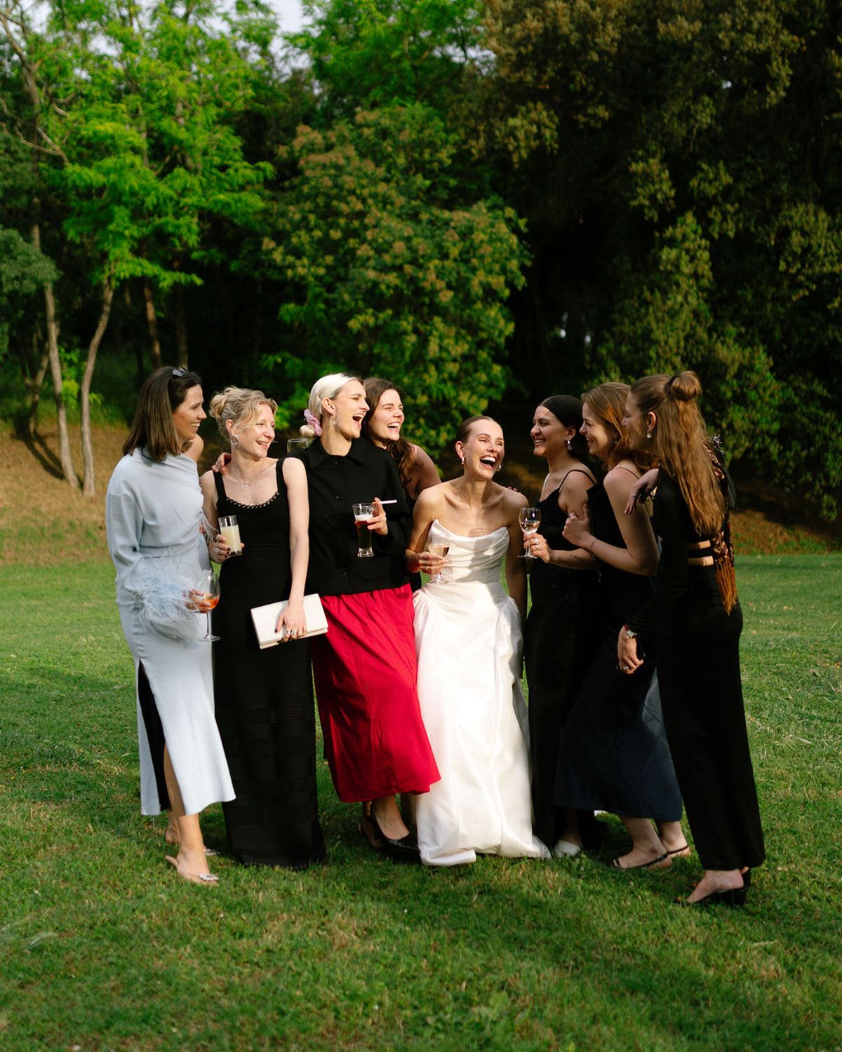 A group of guests walk together on the lawn