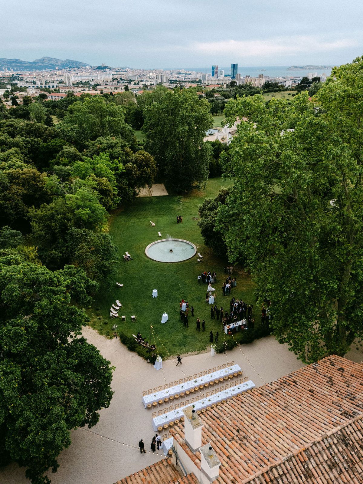 An aerial view of the gardens at Bastide de Toursainte with guests gathered below