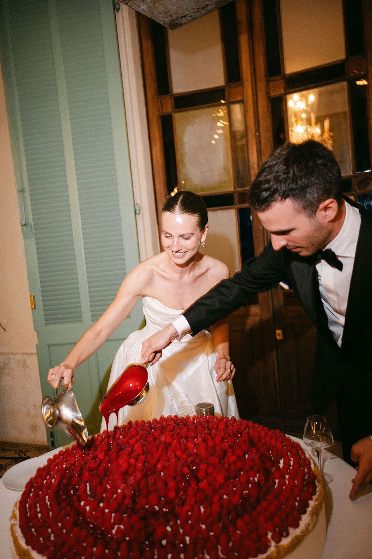 Clara and Constantin light a party popper together indoors during the celebrations