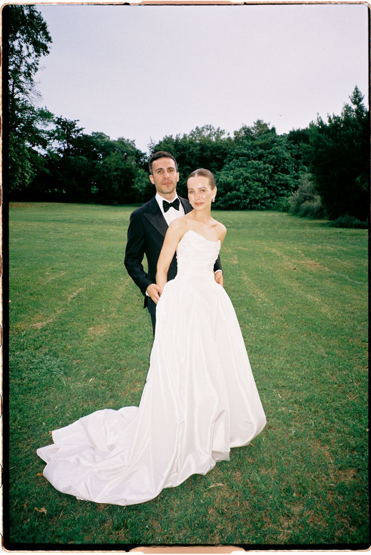 Clara and Constantin stand together on the lawn at Bastide de Toursainte