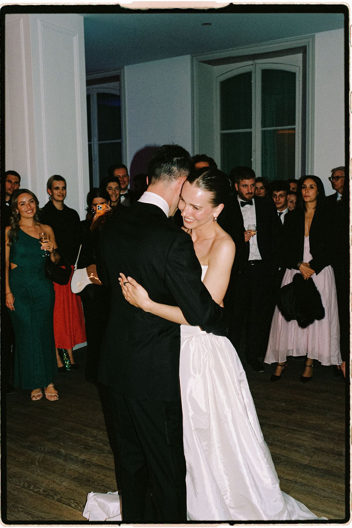 Clara dances with her father as guests look on