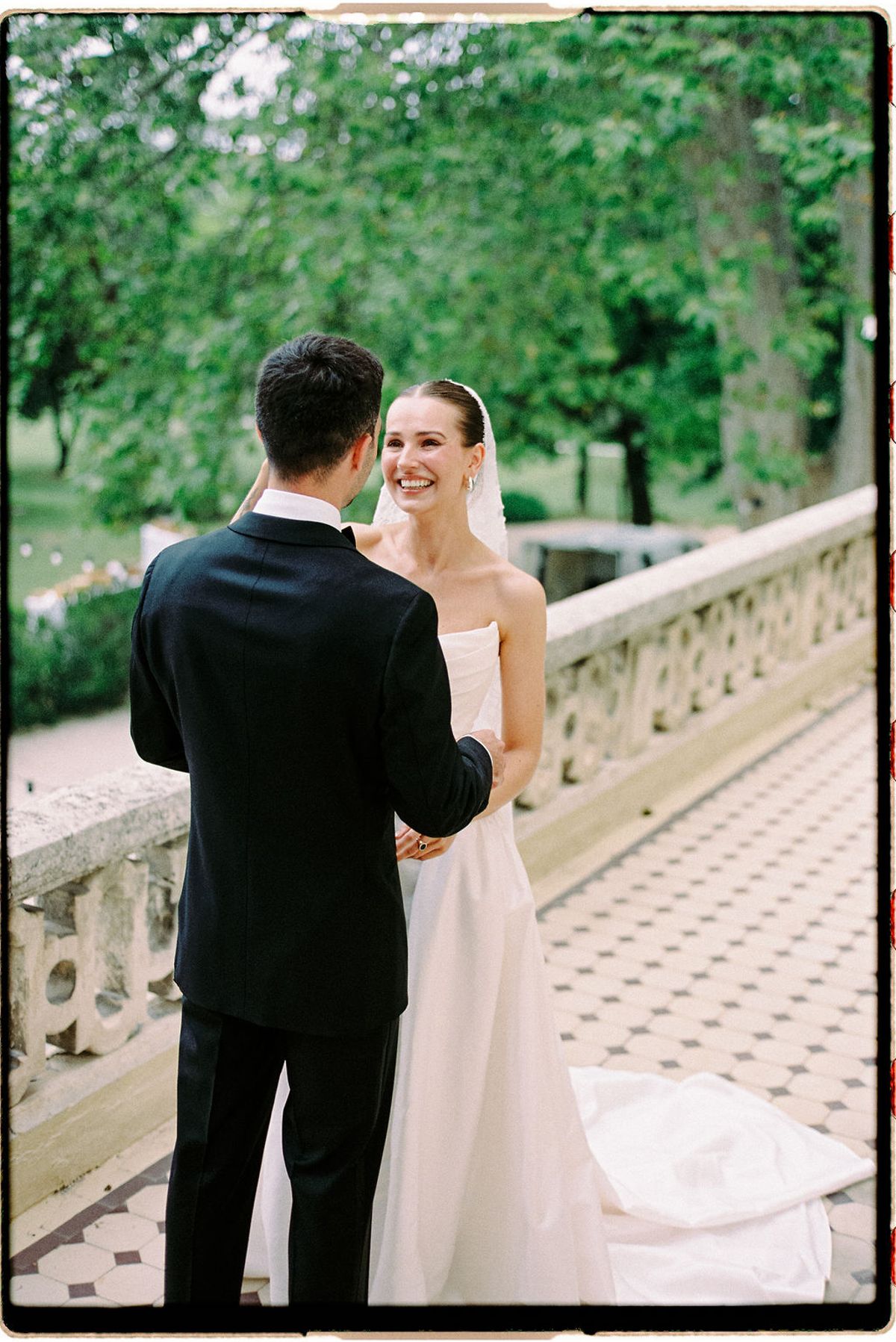 Clara and Constantin laugh together on the terrace