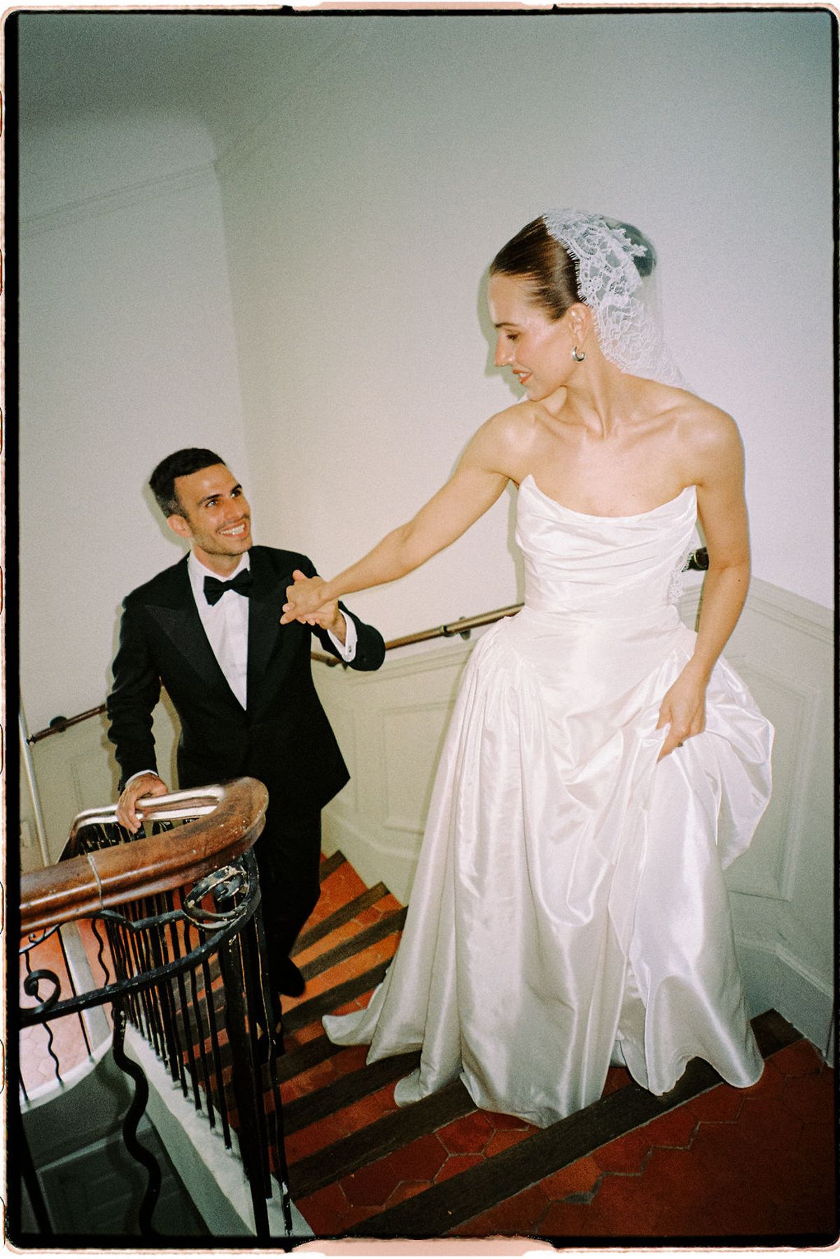 Clara helps adjust Constantin's outfit as they get ready together