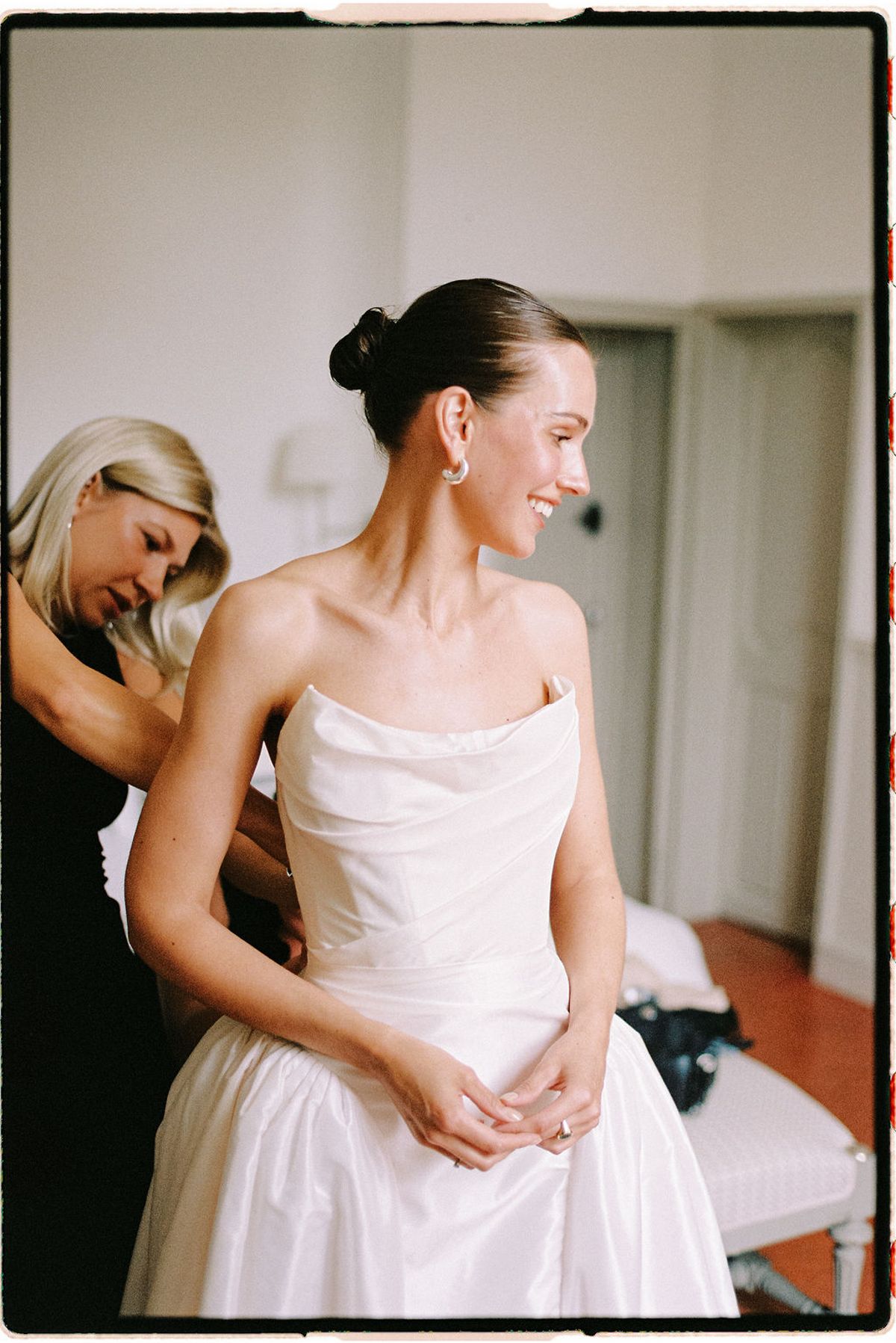 Clara has her earrings adjusted during preparations