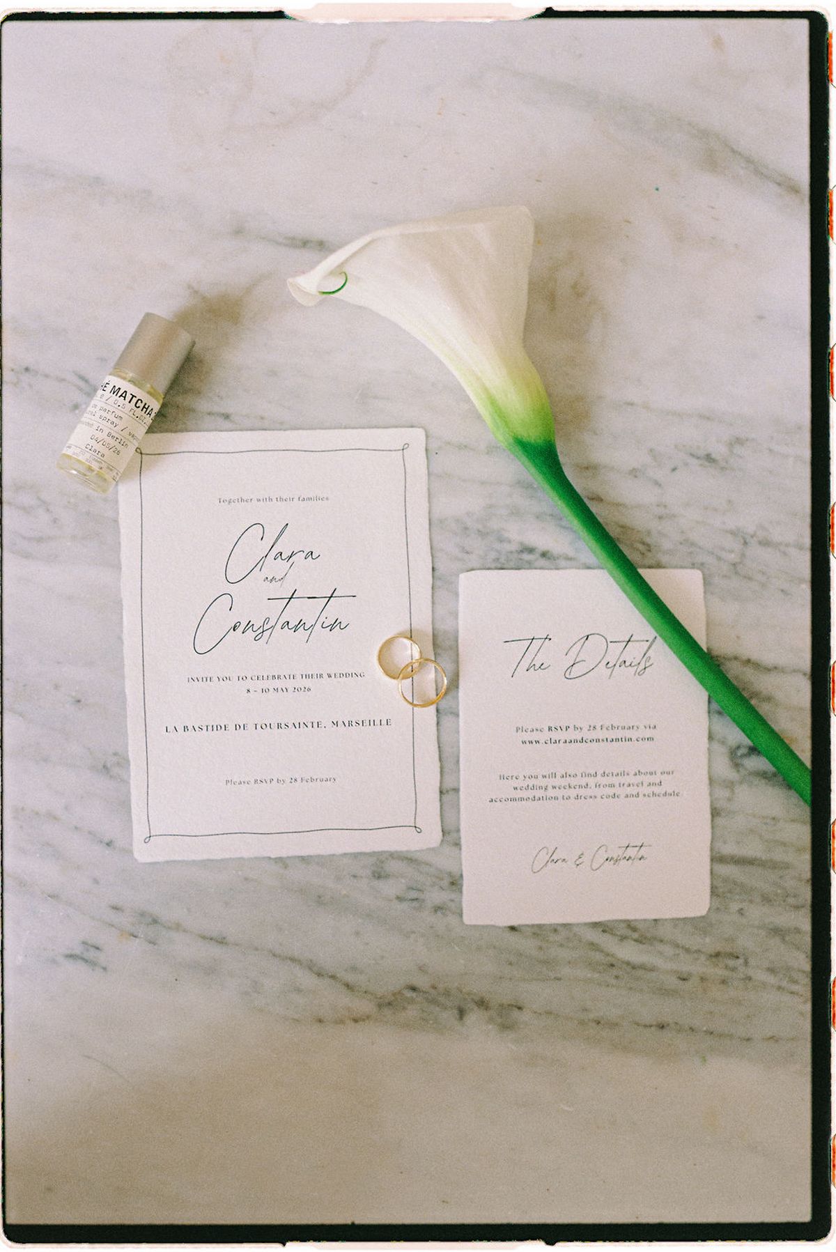 The wedding invitation suite for Clara and Constantin laid out on marble
