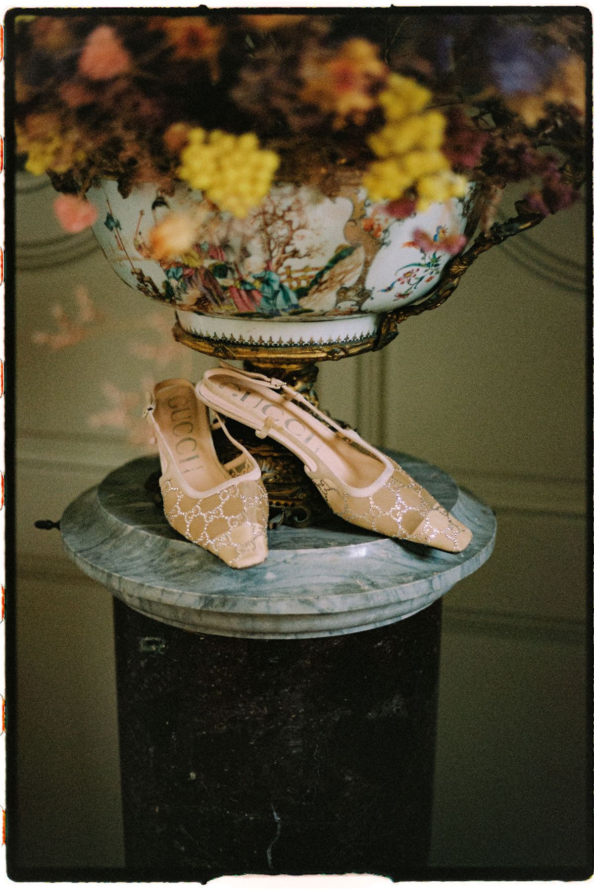 Clara's wedding shoes displayed on an ornate pedestal
