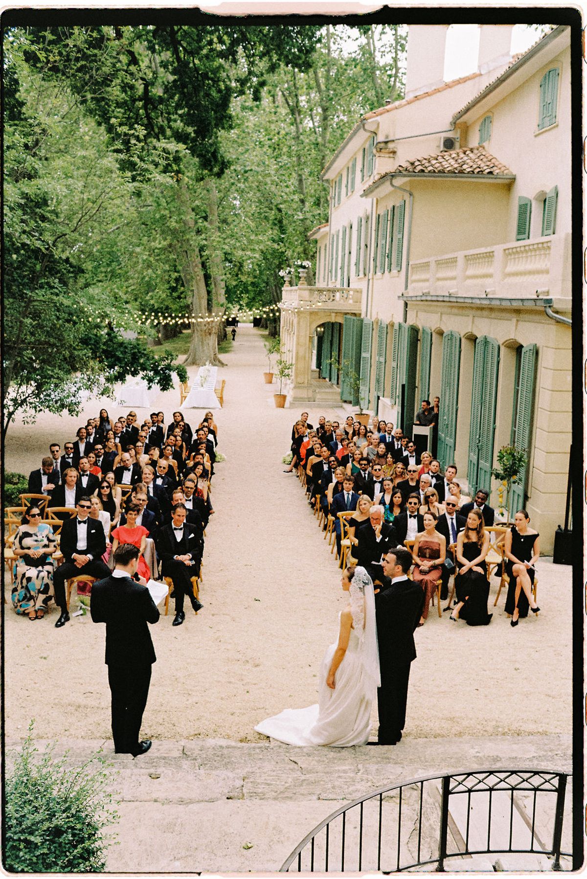 Guests seated on both sides of the aisle for the outdoor ceremony