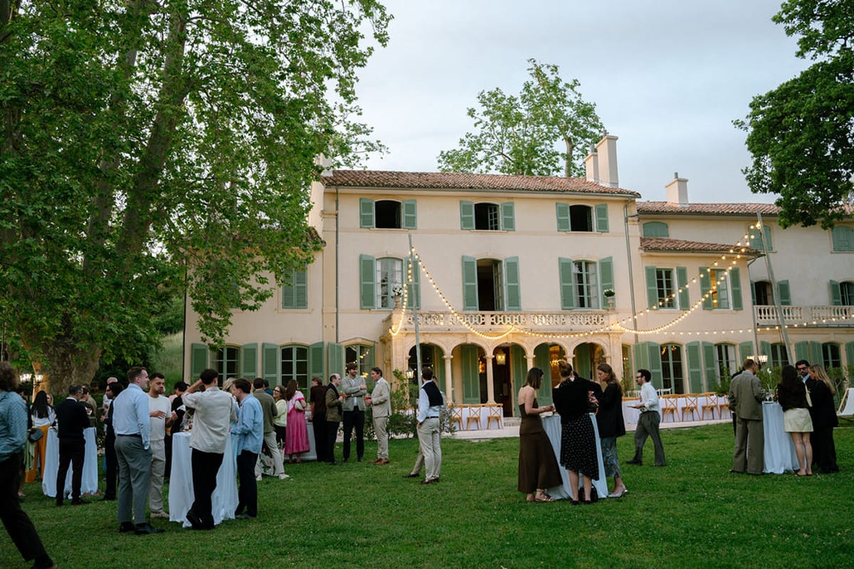 Guests gather on the lawn in front of Bastide de Toursainte