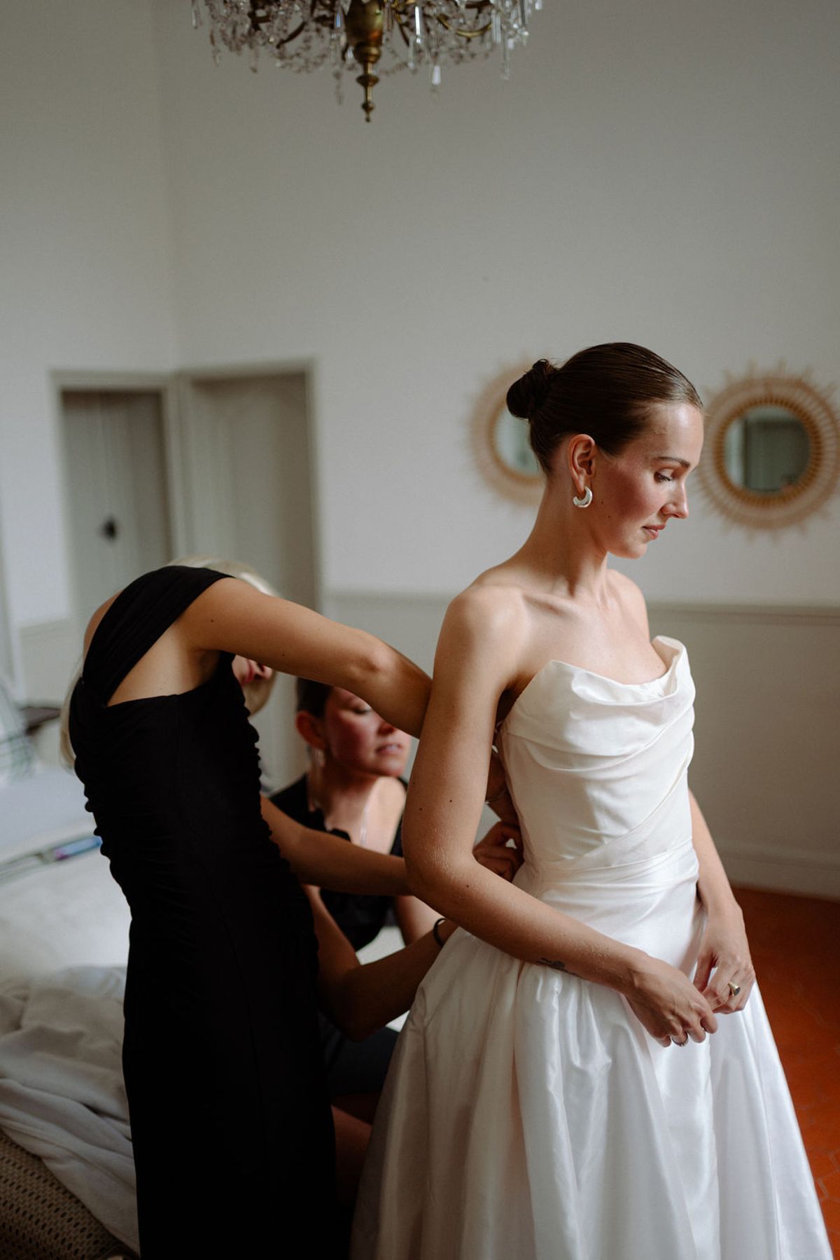 Clara has the final adjustments made to her dress before the ceremony