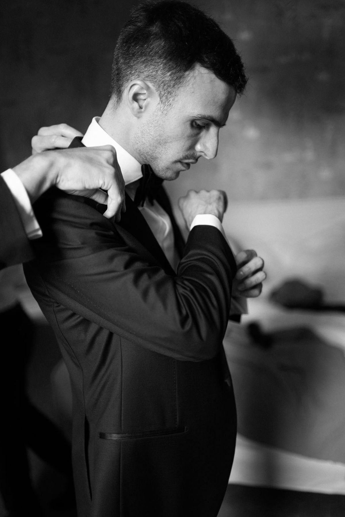 Constantin has his cufflinks fastened while getting ready