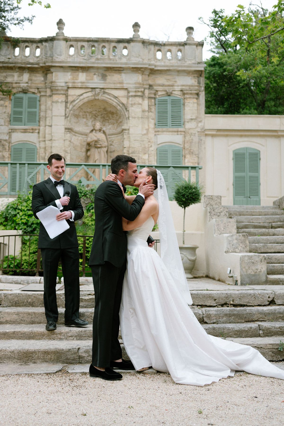 Clara and Constantin embrace at the top of the terrace steps during the ceremony
