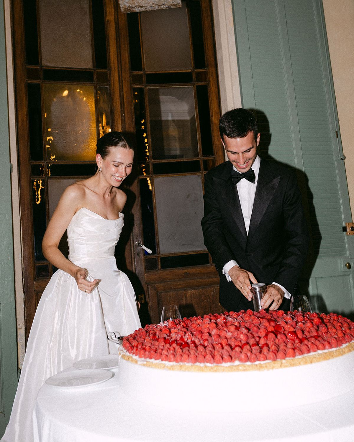 Clara and Constantin stand together at the cake table
