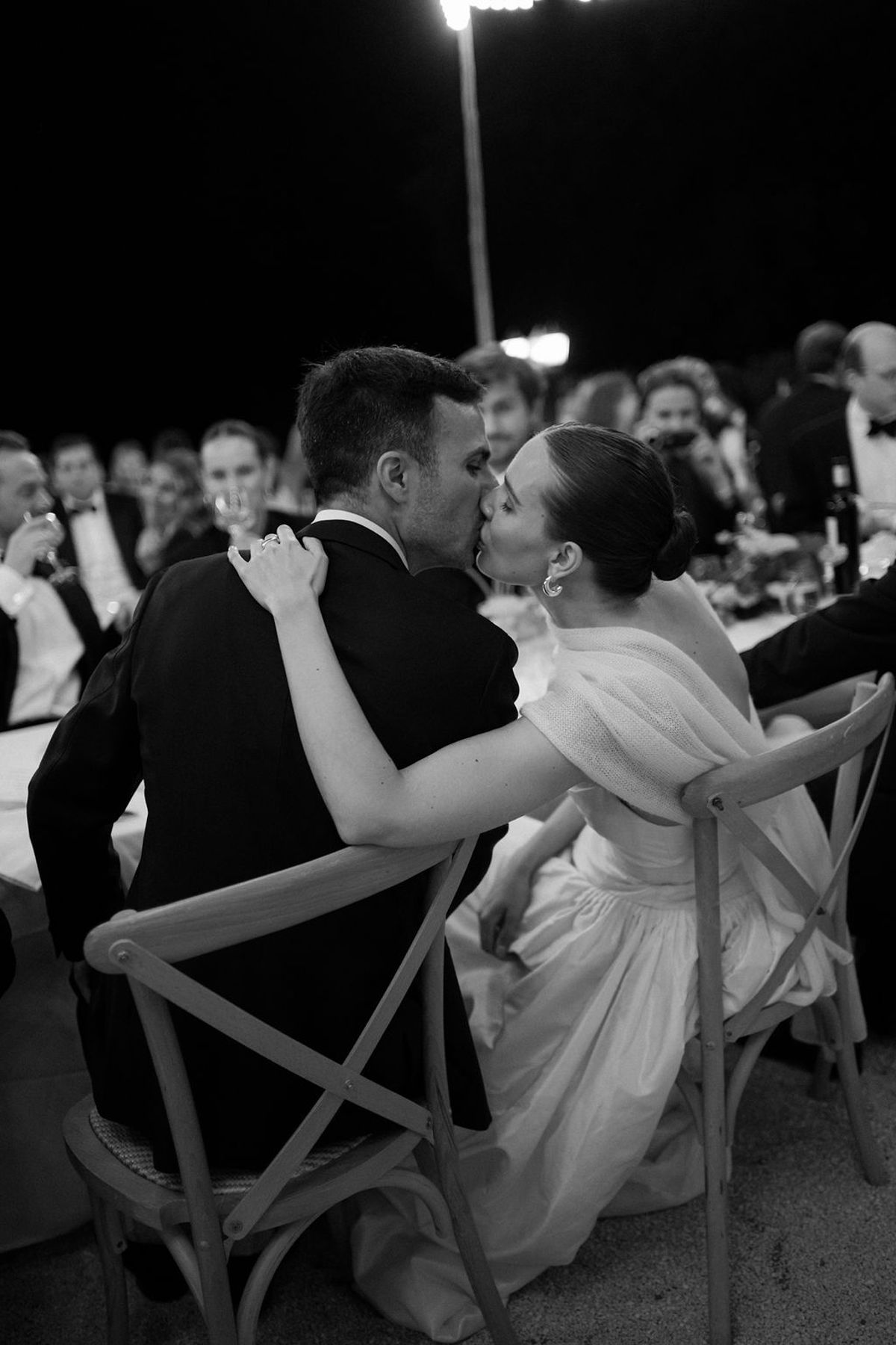 Clara and Constantin share a close moment while seated during the reception