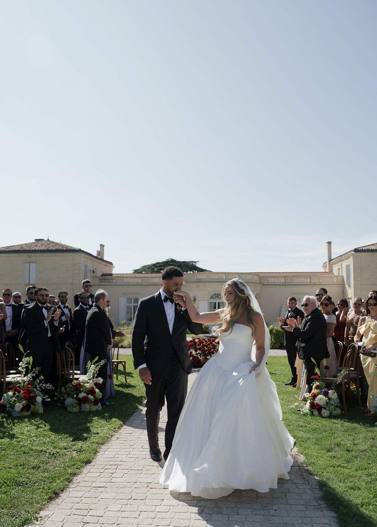 Kendra and Brandon walking back up the aisle as married