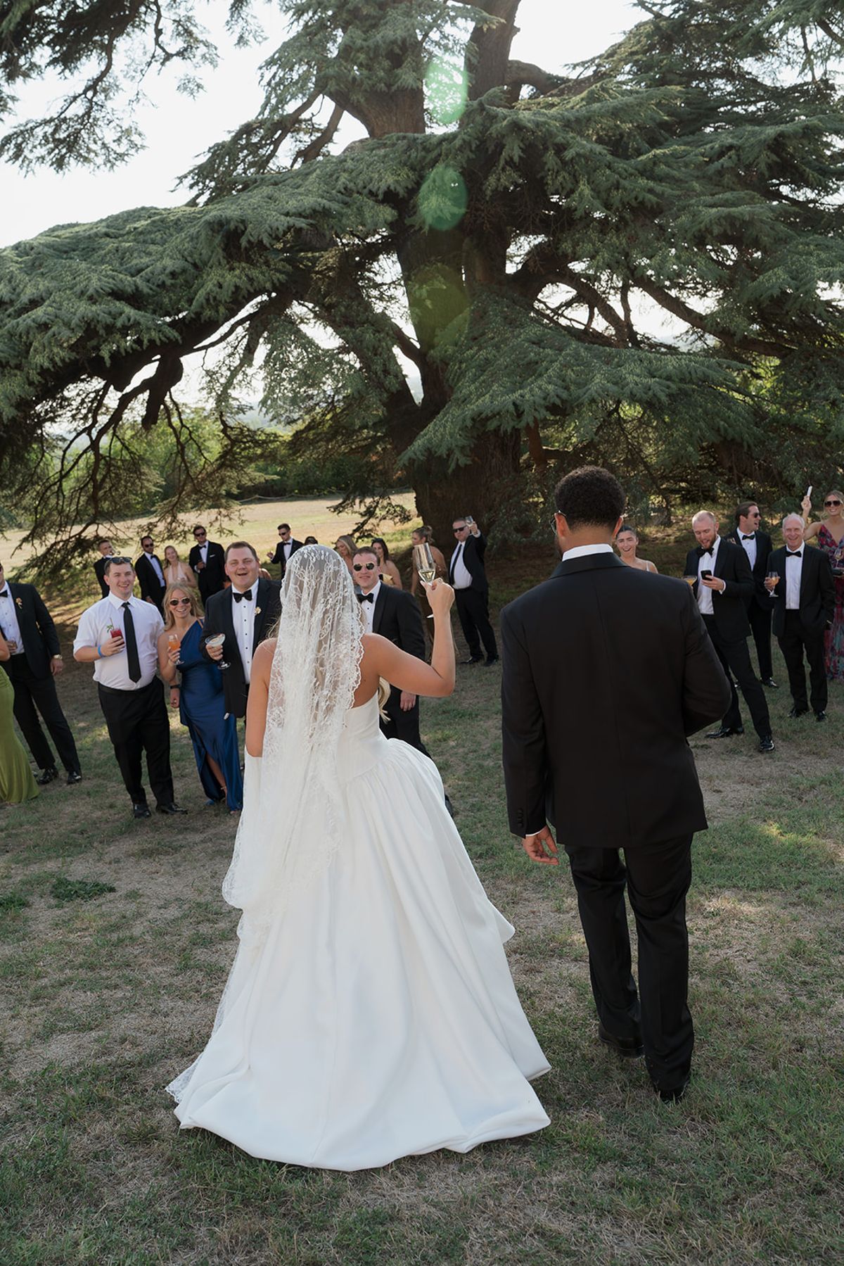 Kendra and Brandon walking across the lawn towards their guests