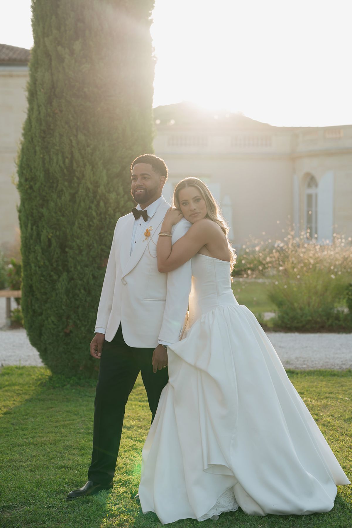 Brandon in a white dinner jacket with Kendra in the evening light