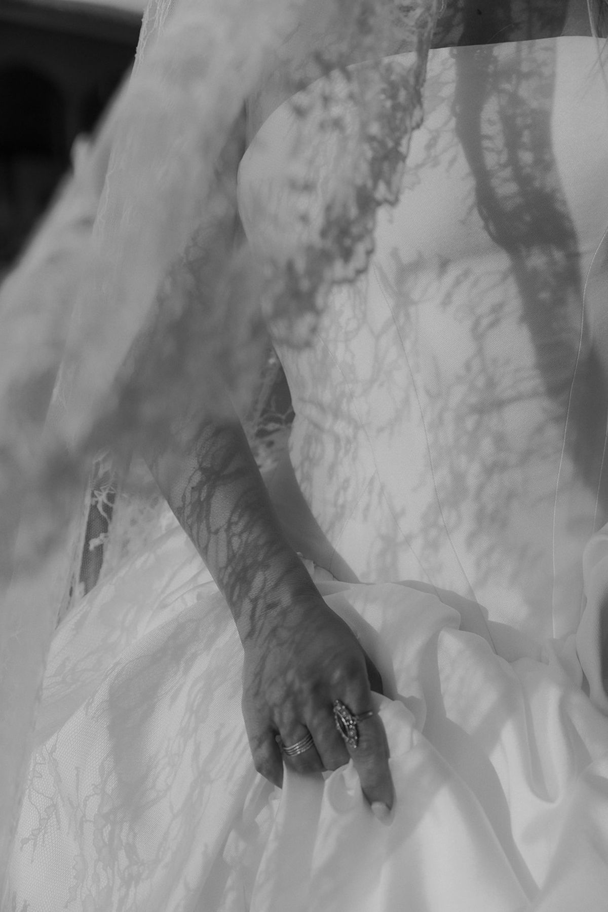 Kendra's hand resting on her gown, black and white