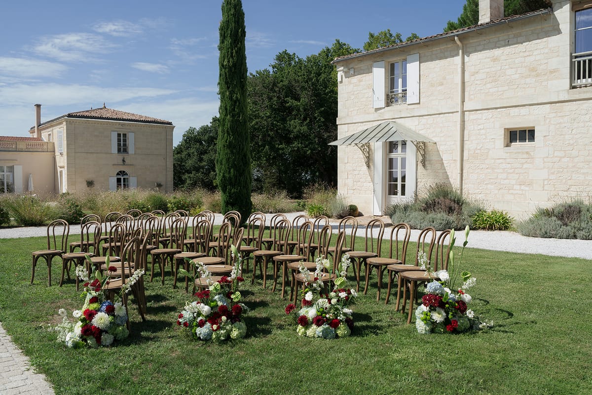 Curved rows of bentwood chairs for the ceremony at Château Gassies