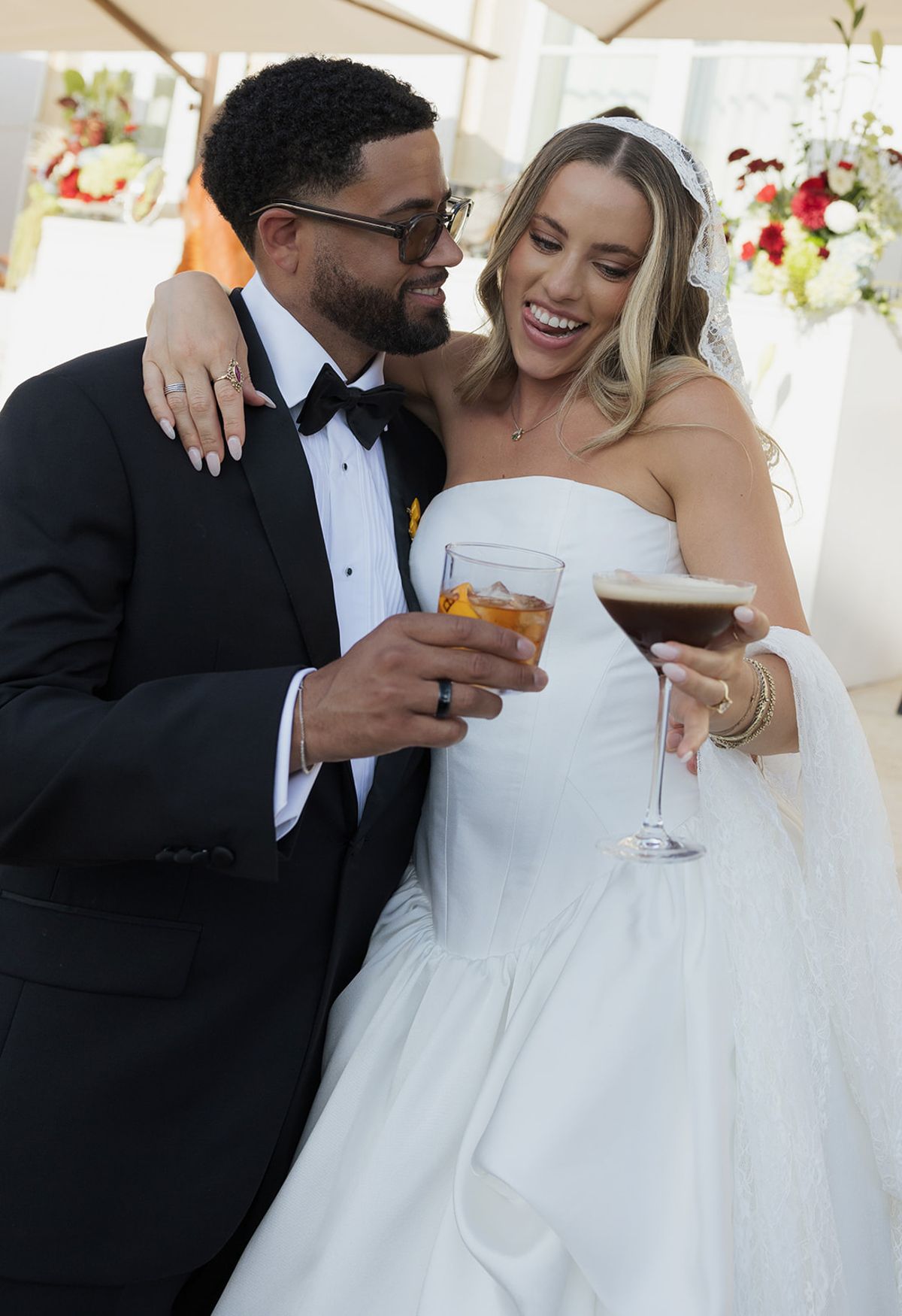 Kendra and Brandon laughing with drinks in hand