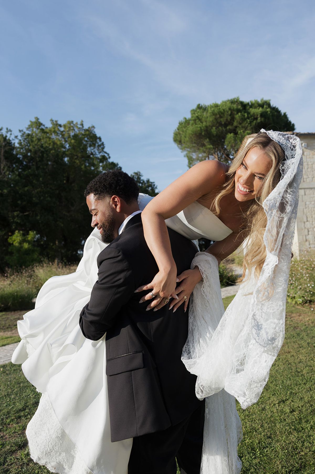 Brandon lifting Kendra in the garden