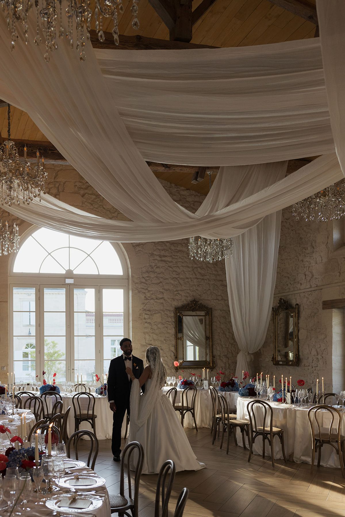 Kendra and Brandon in the reception room beneath the drapery