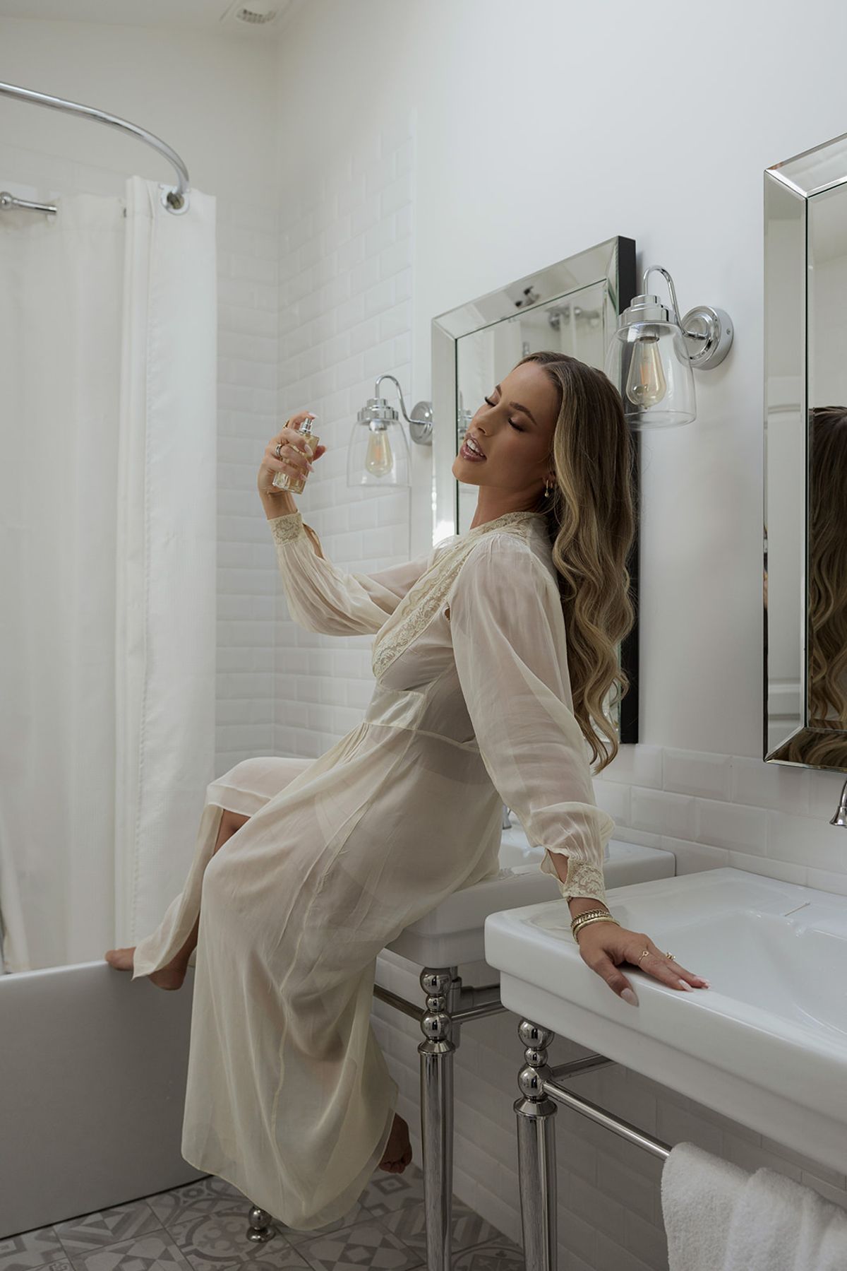 Kendra sitting by the sink in her robe while getting ready
