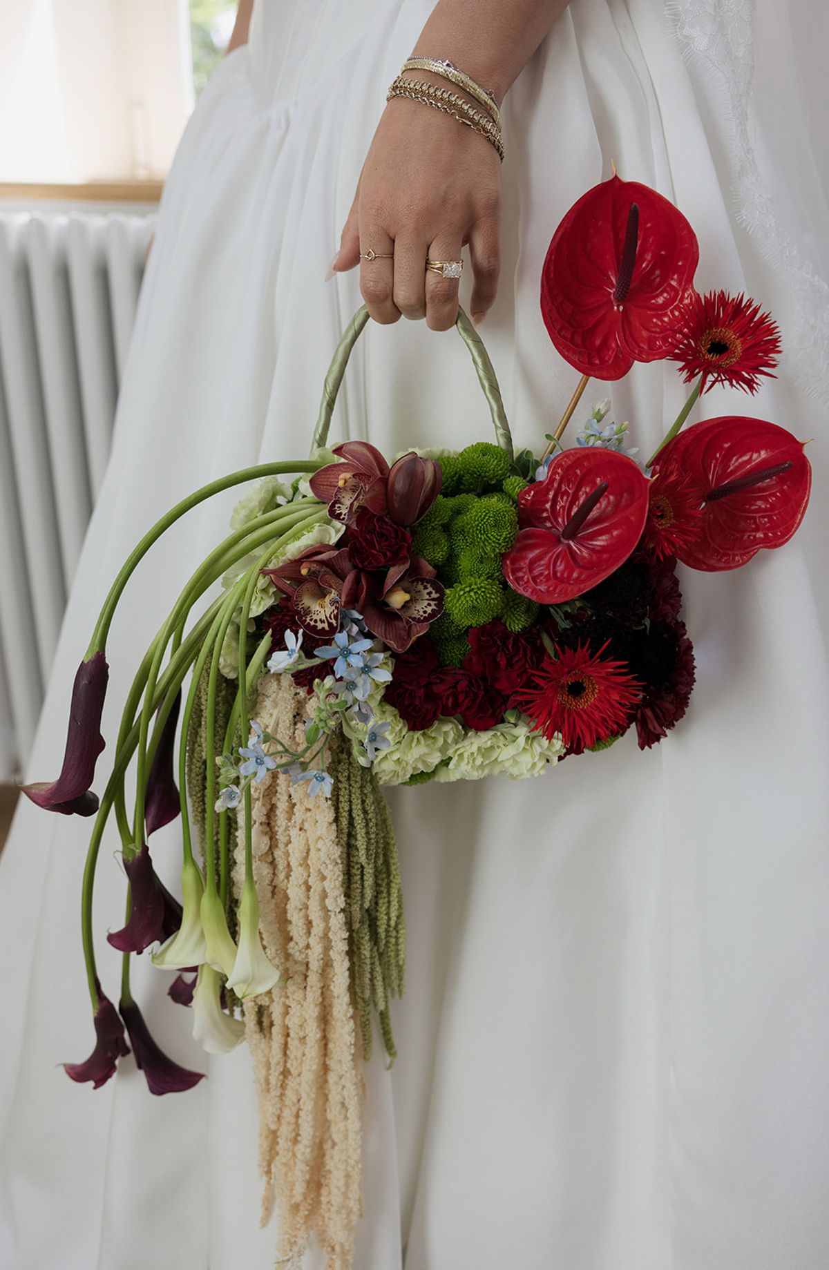 Kendra holding her bouquet with trailing stems