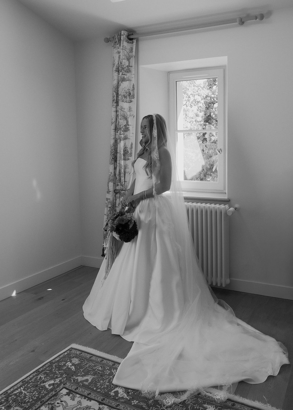 Kendra in her strapless gown by a window in her room