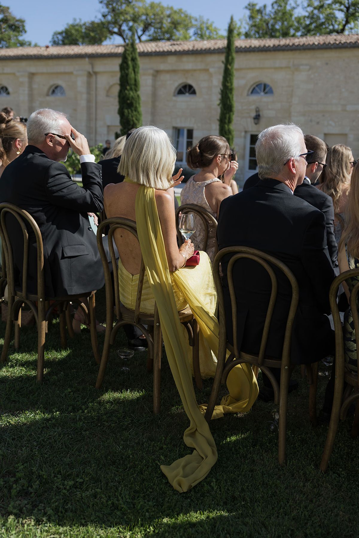 Guests seated on bentwood chairs during the ceremony