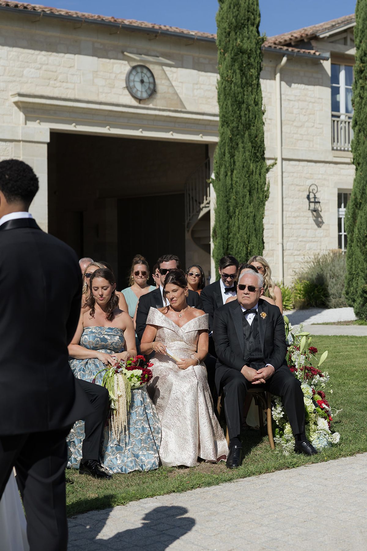 Guests watching the ceremony in front of the château clock tower