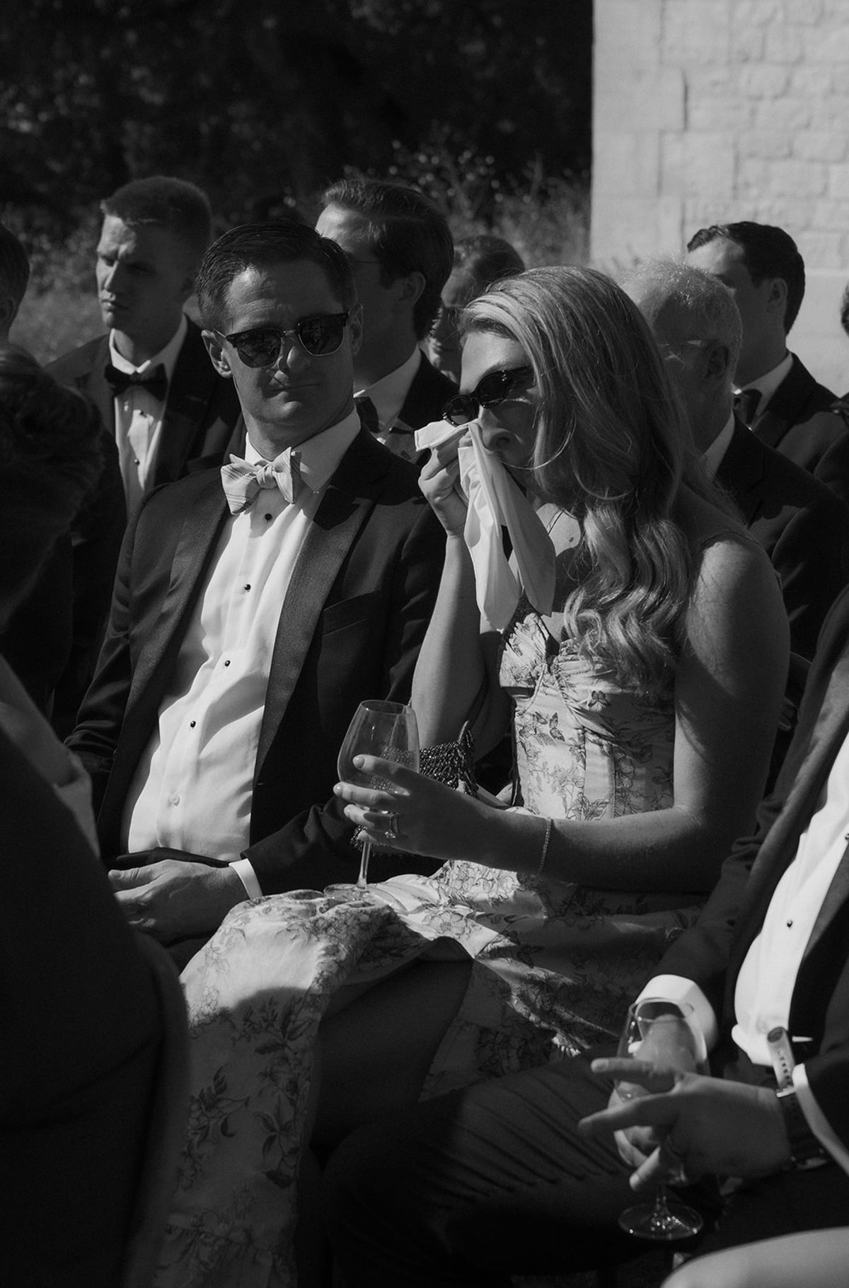 Guests reacting during the ceremony, black and white