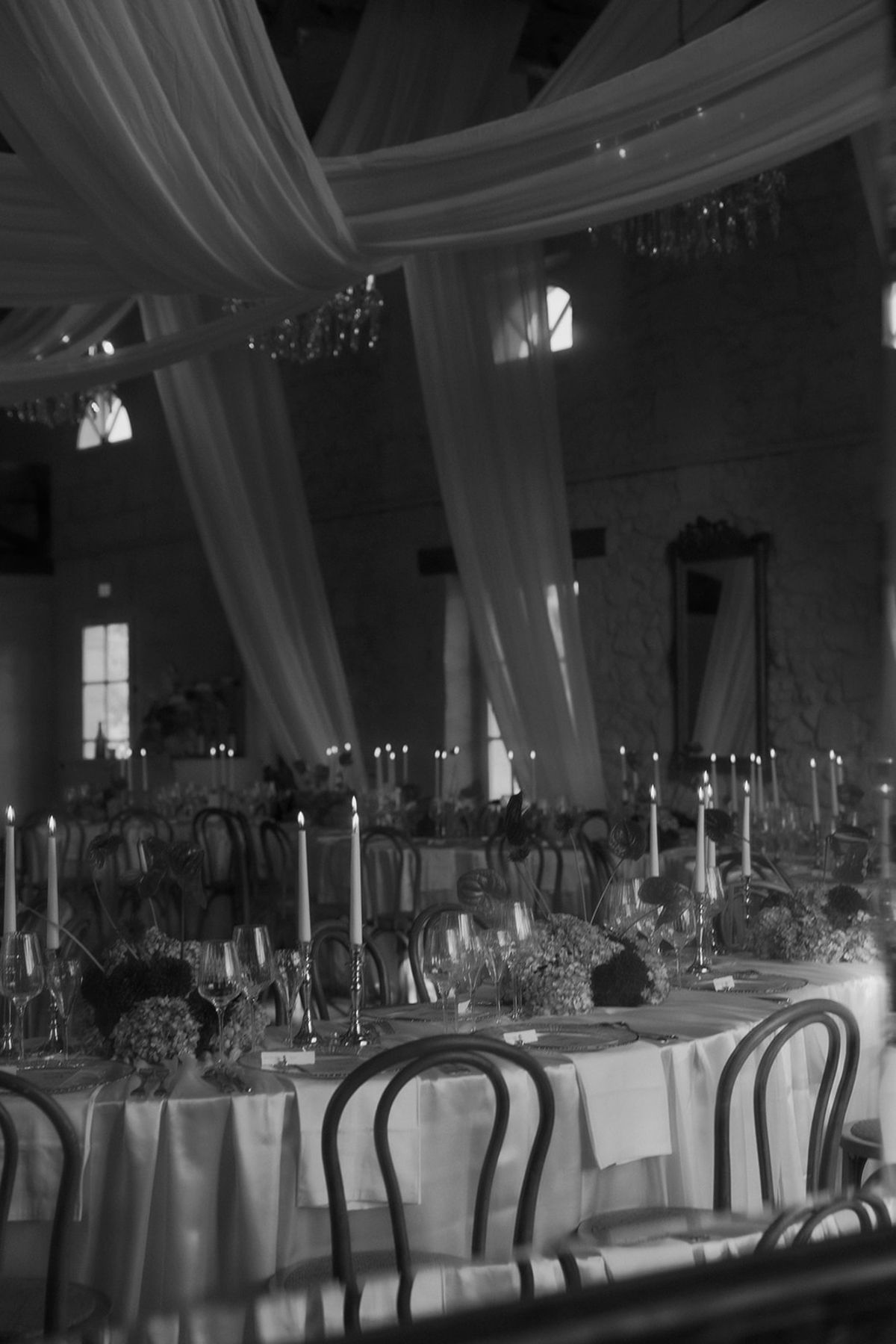 Candlelit tables beneath the draped ceiling, black and white