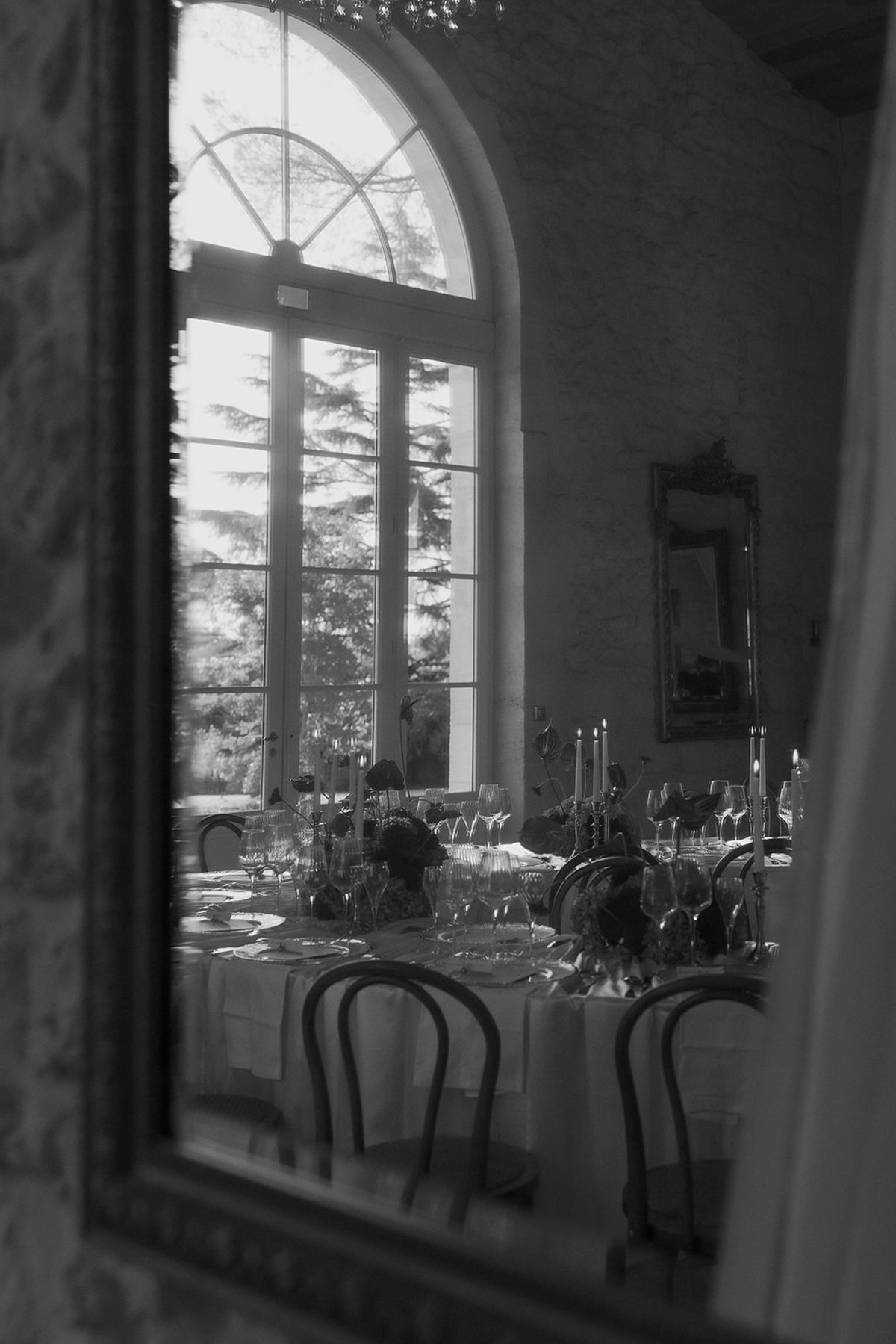 The draped reception room reflected in a mirror