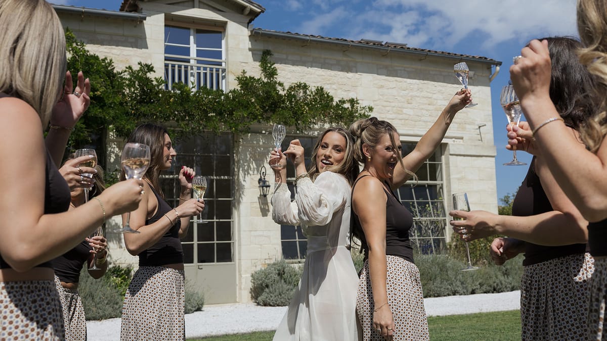 Kendra and friends raising glasses outside the château