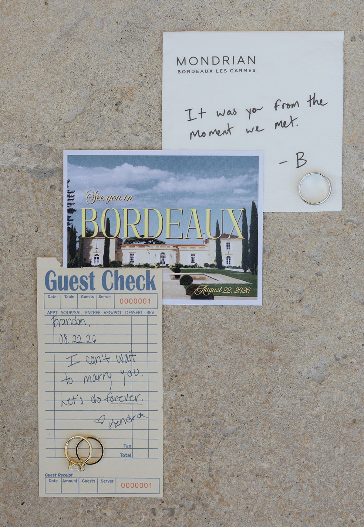 Wedding stationery with a Bordeaux postcard and a handwritten note