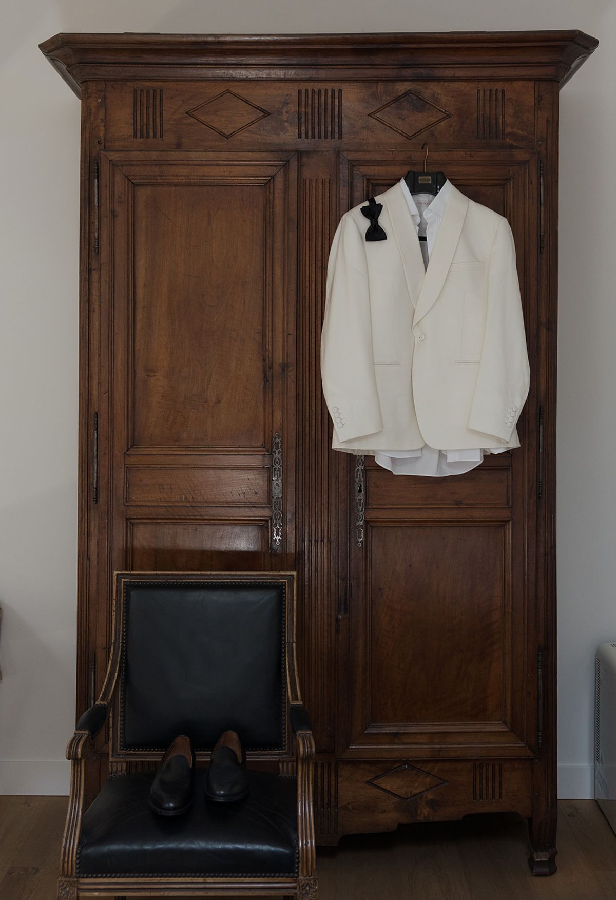Brandon's white dinner jacket hanging on an armoire