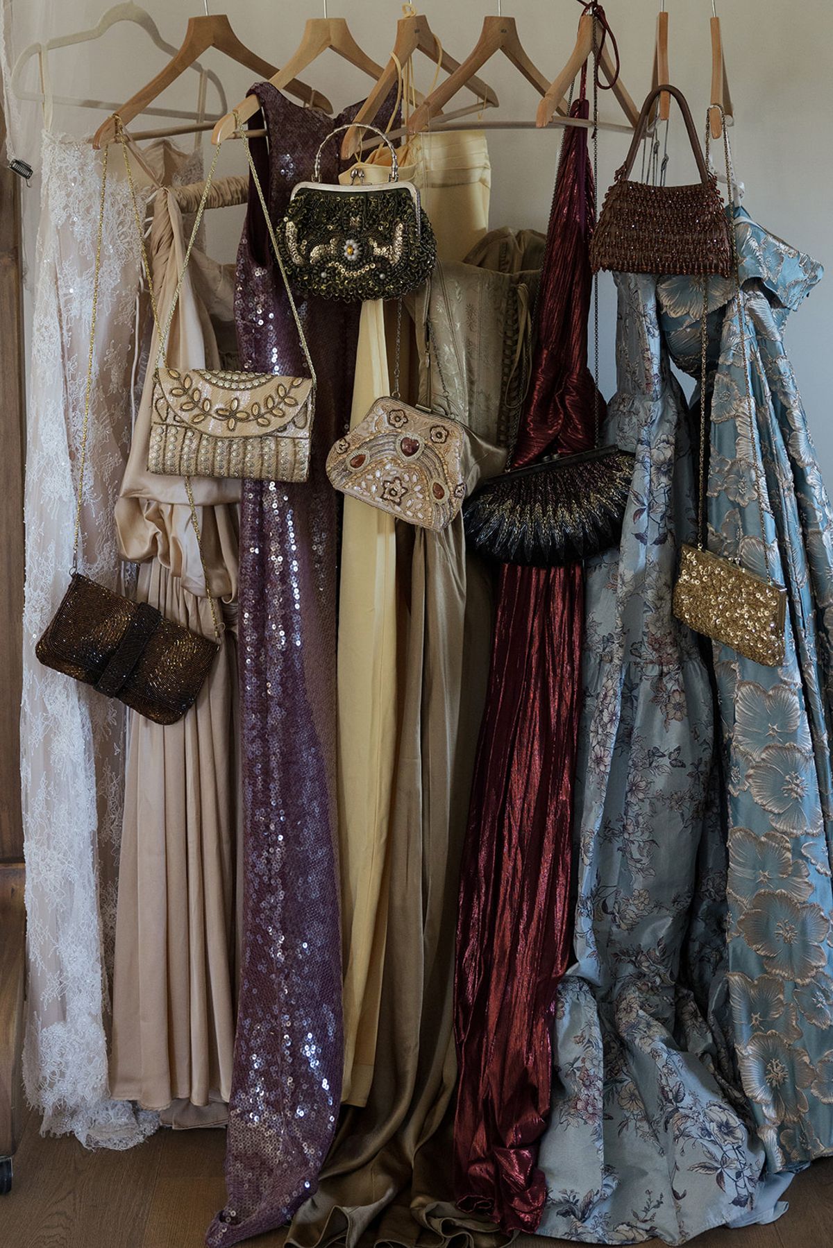 Bridesmaids' dresses and beaded bags on a rail