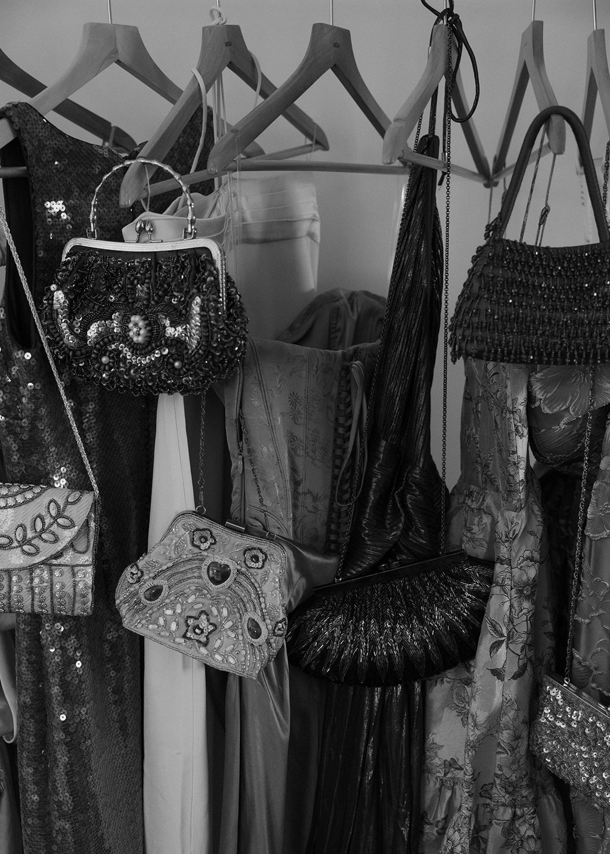 Bridesmaids' dresses and beaded bags hanging on a rail